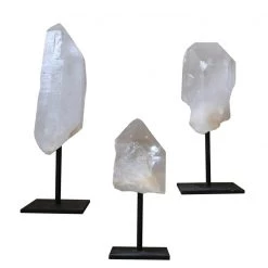 A Modern Grand Tour Curiosities Set Of Three Clear Quartz Crystals Mounted On Black Metal Stands