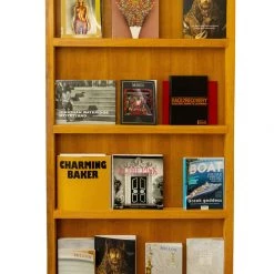 A Modern Grand Tour Furniture A Large Carved Oak Free Standing Magazine Rack